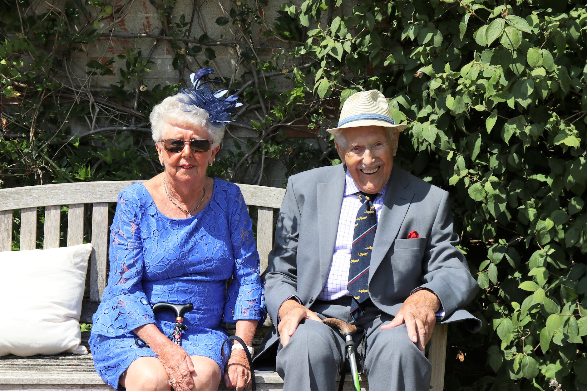 woman sitting beside man on wooden bench