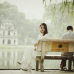 woman sitting on bench outdoors