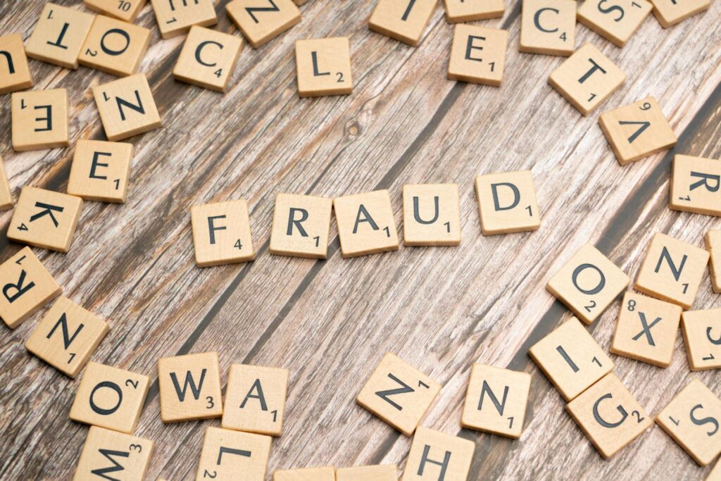 the word fraud spelled out in scrabble letters