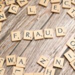 the word fraud spelled out in scrabble letters