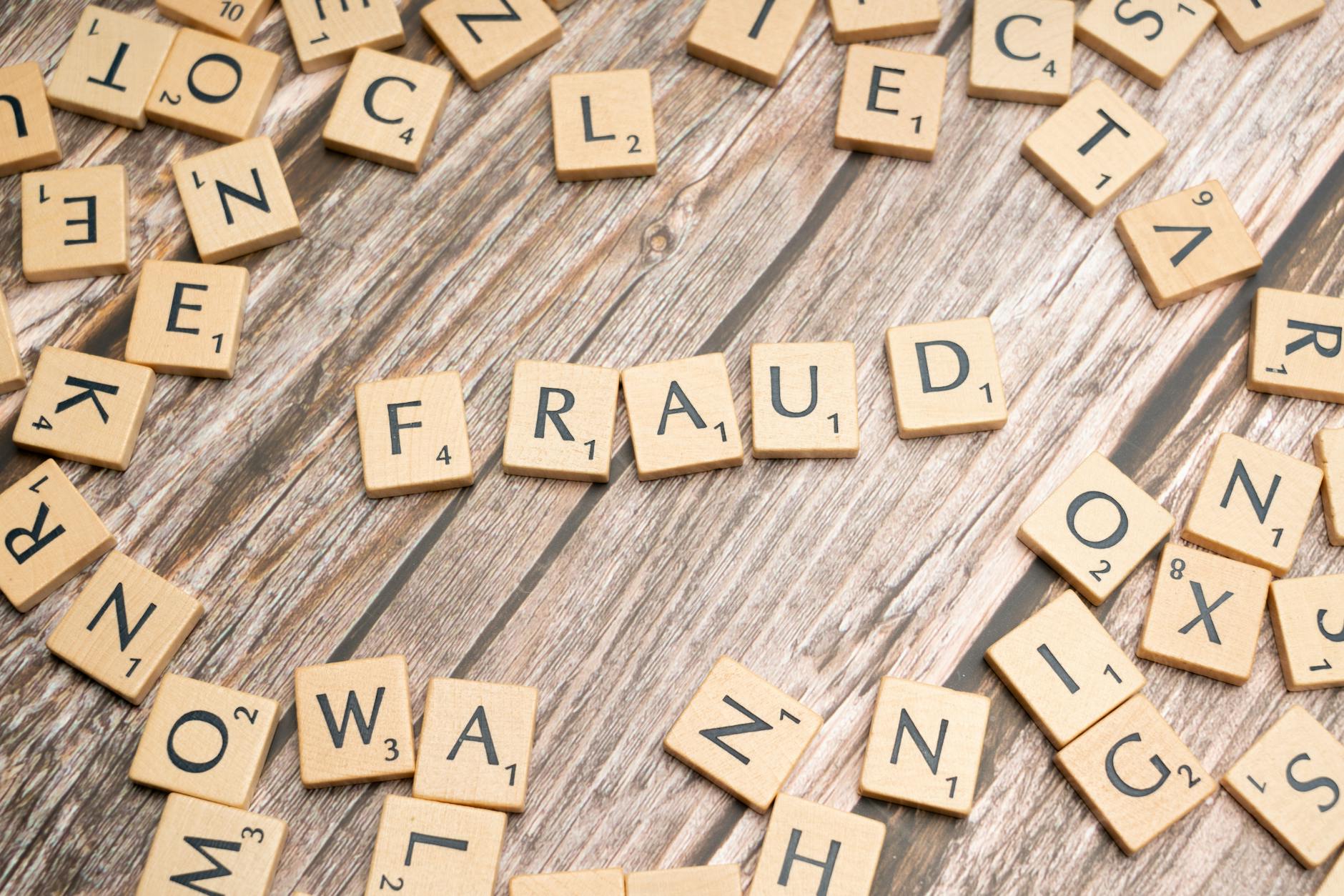 the word fraud spelled out in scrabble letters