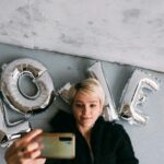 a woman doing selfie using a smartphone